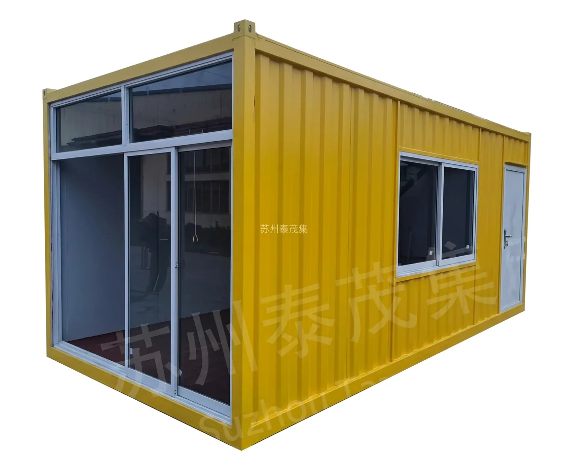 Yellow welded container house with large glazed sliding doors